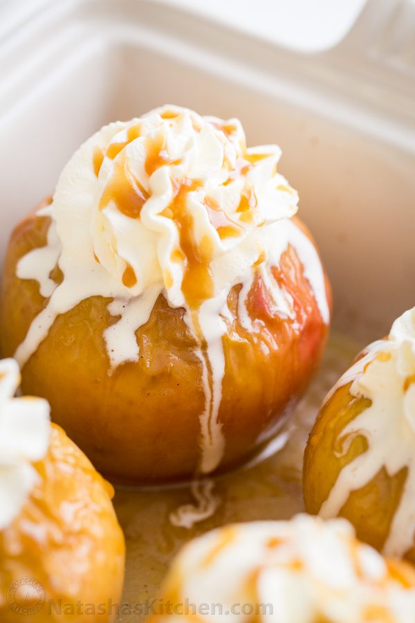 A plate of baked apples topped with vanilla ice cream