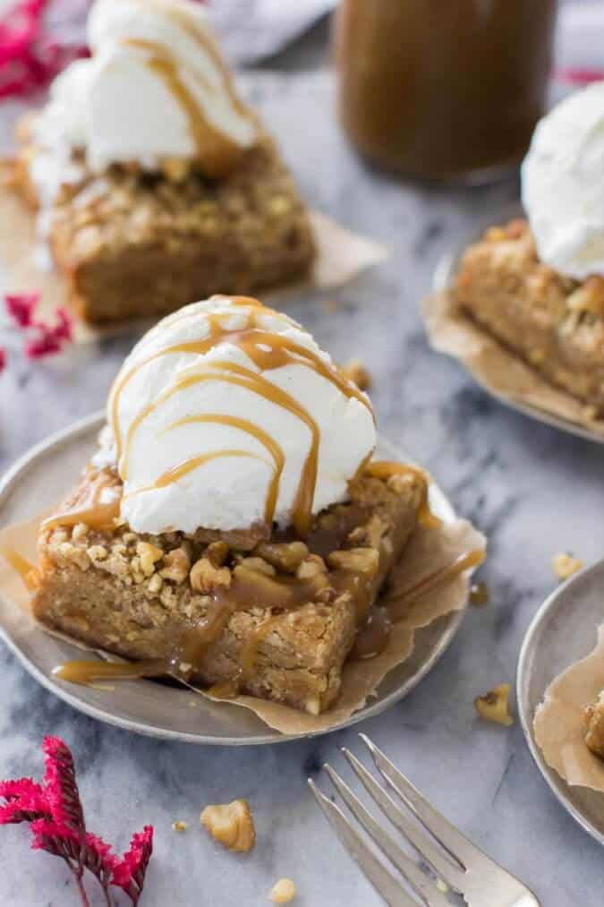 Blondie with walnut crumble and vanilla ice cream on a plate