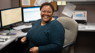 Smiling TriMark United East employee at her desk