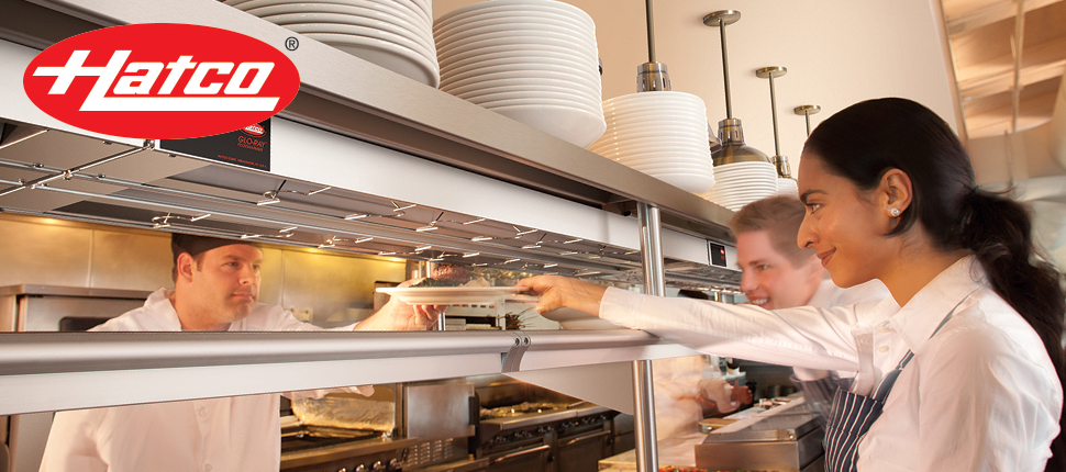 Chef handing waitress a plate of food