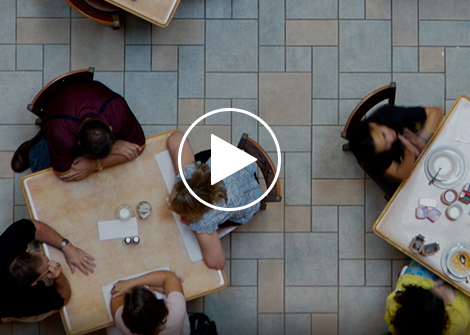 Groups of people eating in a cafeteria