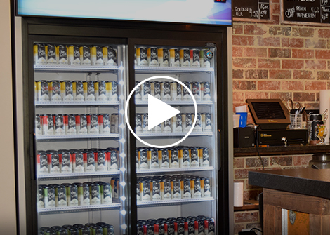 Drink merchandiser behind counter in cafe