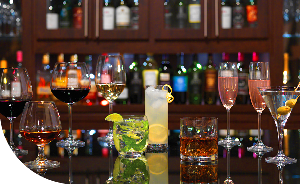 Bar counter with various prepared drinks on display