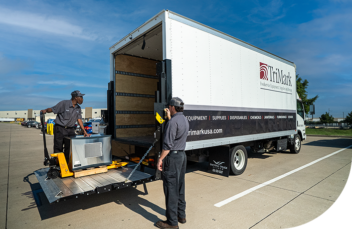 TriMark Employees lowering rental equipment from delivery truck